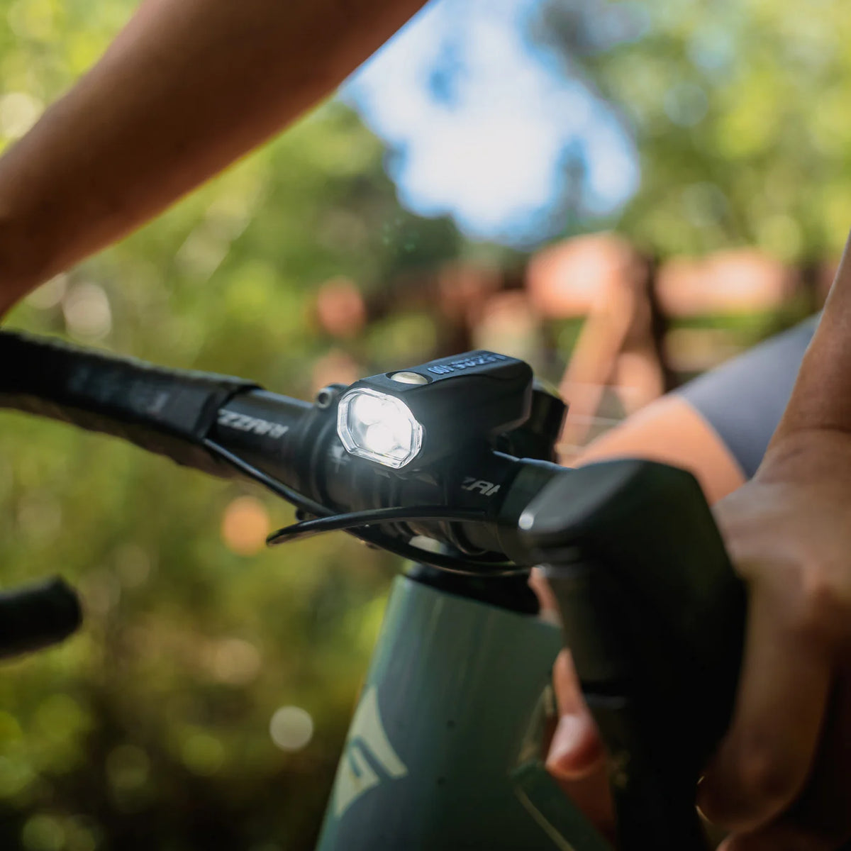 Close-up of the Lezyne KTV Drive Pro 400 front light mounted on a bicycle handlebar.