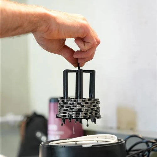 CeramicSpeed hot wax chain hanger demonstrating wax application process in use.