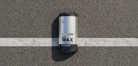 CeramicSpeed UFO Speed Wax kit lying on asphalt, showcasing the packaging for optimal chain treatment.