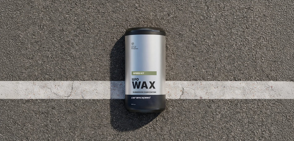 CeramicSpeed UFO Speed Wax kit lying on asphalt, showcasing the packaging for optimal chain treatment.