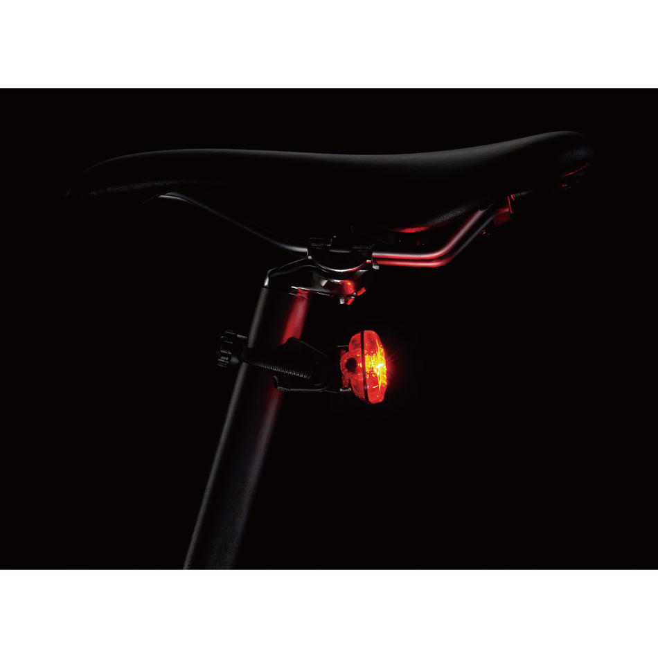 CatEye Omni 3 rear light mounted on a bicycle seat post, showcasing its bright LED visibility.