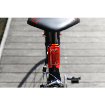 CatEye kinetic rear bike light mounted on a bike seat post for enhanced visibility and safety.