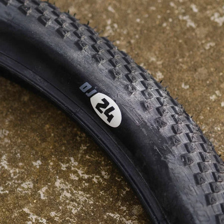 DMR DJ24 dirt jump tyre close-up showcasing tread pattern and size, ideal for 24 inch dirt jump tyres.