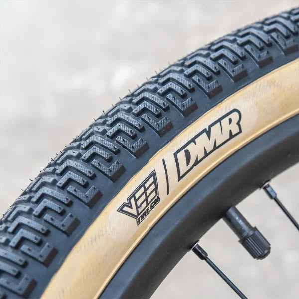 DMR Moto DJ jump dirt track tyre with skinwall design showcasing tread pattern on a bicycle wheel.
