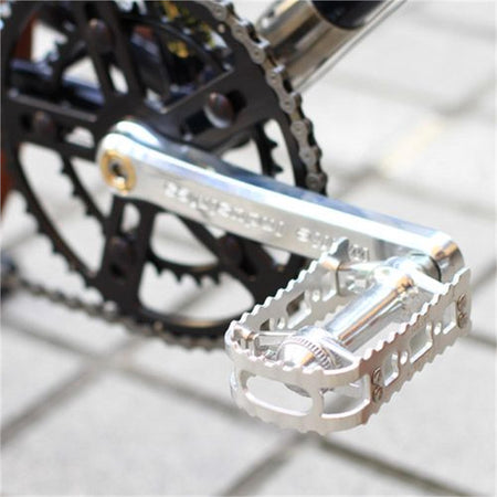 MKS BM-7 BMX pedals installed on a bike crank with a black chainring.