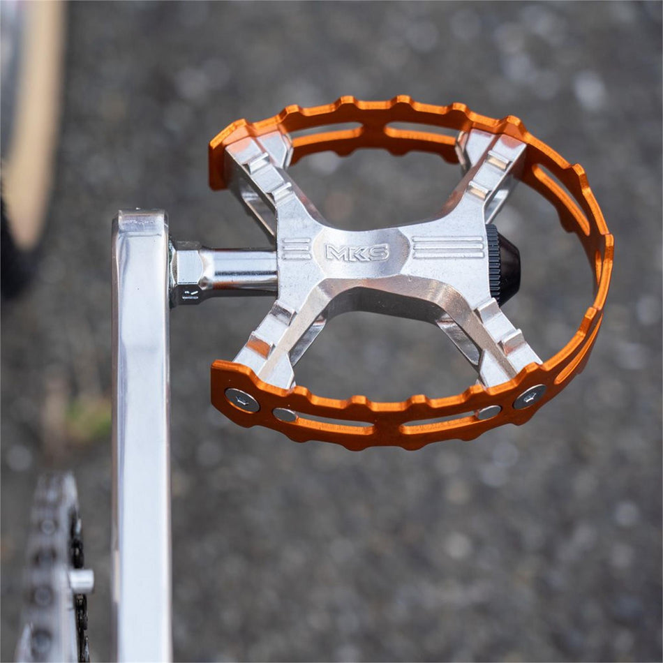 MKS XC-III Bear Trap flat pedals in orange, showcasing a wide platform for grip and stability.