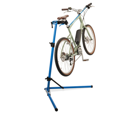 Home mechanic bike repair stand holding a bicycle in an elevated position for easy maintenance and repairs.