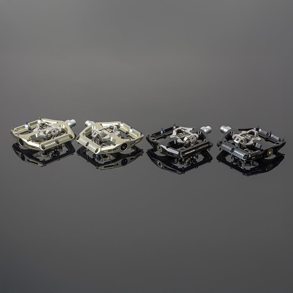 Renthal Revo-DHC large platform MTB clip pedals on reflective surface, showcasing various color options and designs.