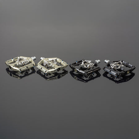 Renthal Revo-DHC large platform MTB clip pedals on reflective surface, showcasing various color options and designs.