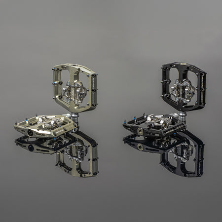 Renthal Revo-DHC Clip large platform MTB clip pedals in gold and black with reflections.