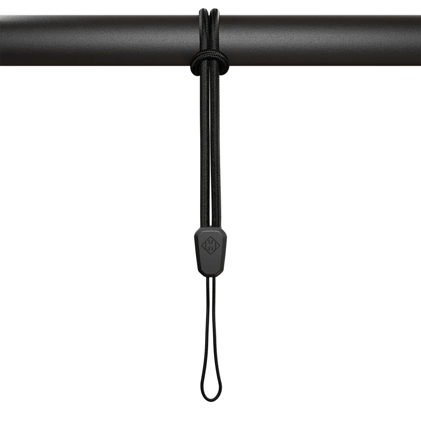 Hammerhead Karoo safety lanyard hanging on a bar, designed to securely hold Karoo devices.