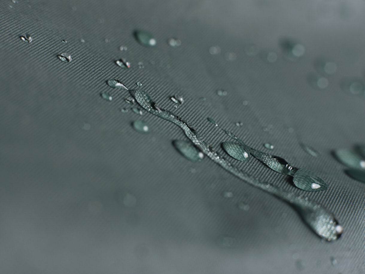 Close-up of water droplets on VK "Re-Cover" Duo waterproof bicycle cover for 2 bikes in forest green.