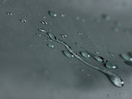 Close-up of water droplets on VK "Re-Cover" Duo waterproof bicycle cover for 2 bikes in forest green.