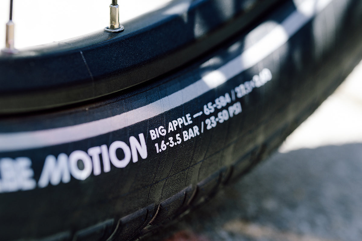 Close-up of Schwalbe Motion Big Apple urban wired bike tyre showing specifications and design details.