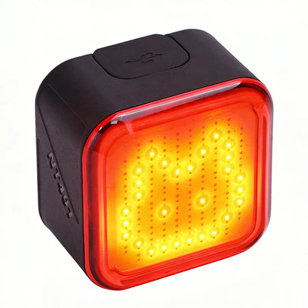 Ravemen NT401 rechargeable bike tail light with emoji displaying a custom light pattern.