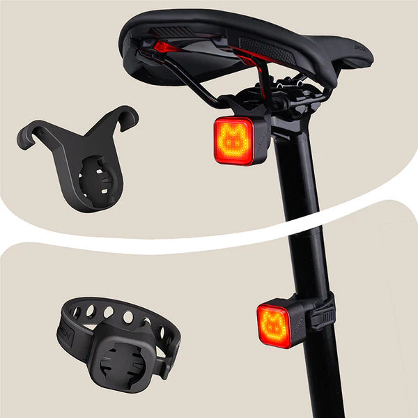 Ravemen NT401 rechargeable bike tail light with emoji mounted on a bike saddle with accessories.