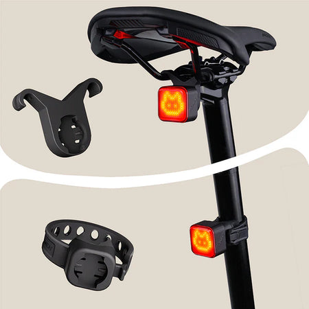 Ravemen NT401 rechargeable bike tail light with emoji mounted on a bike saddle with accessories.