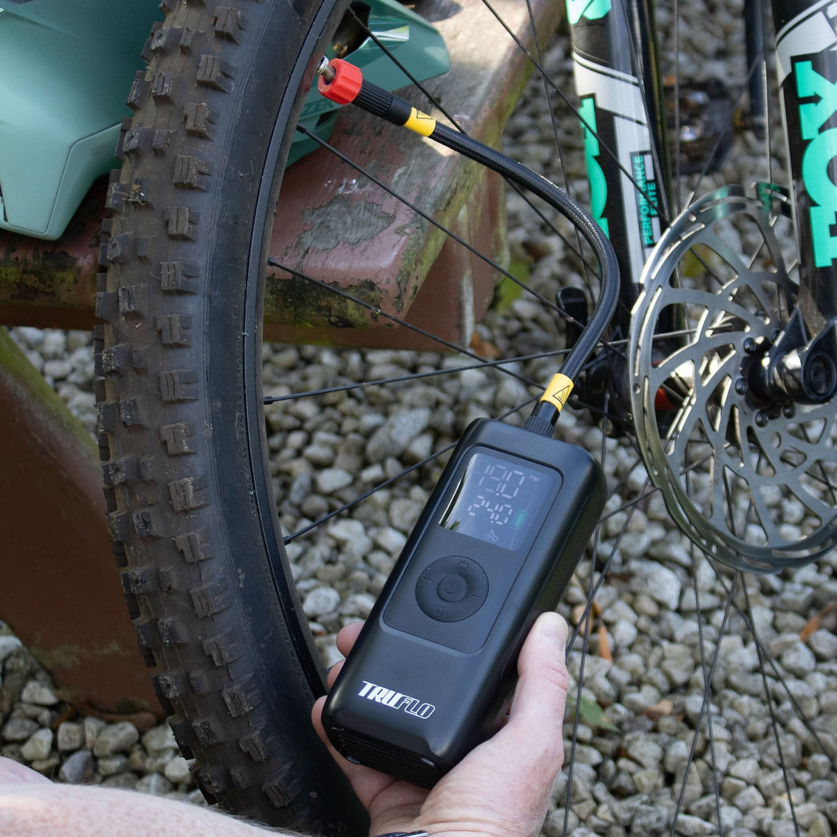 Electron Max Electric Pump for bikes and scooters inflating a bicycle tyre with digital display.