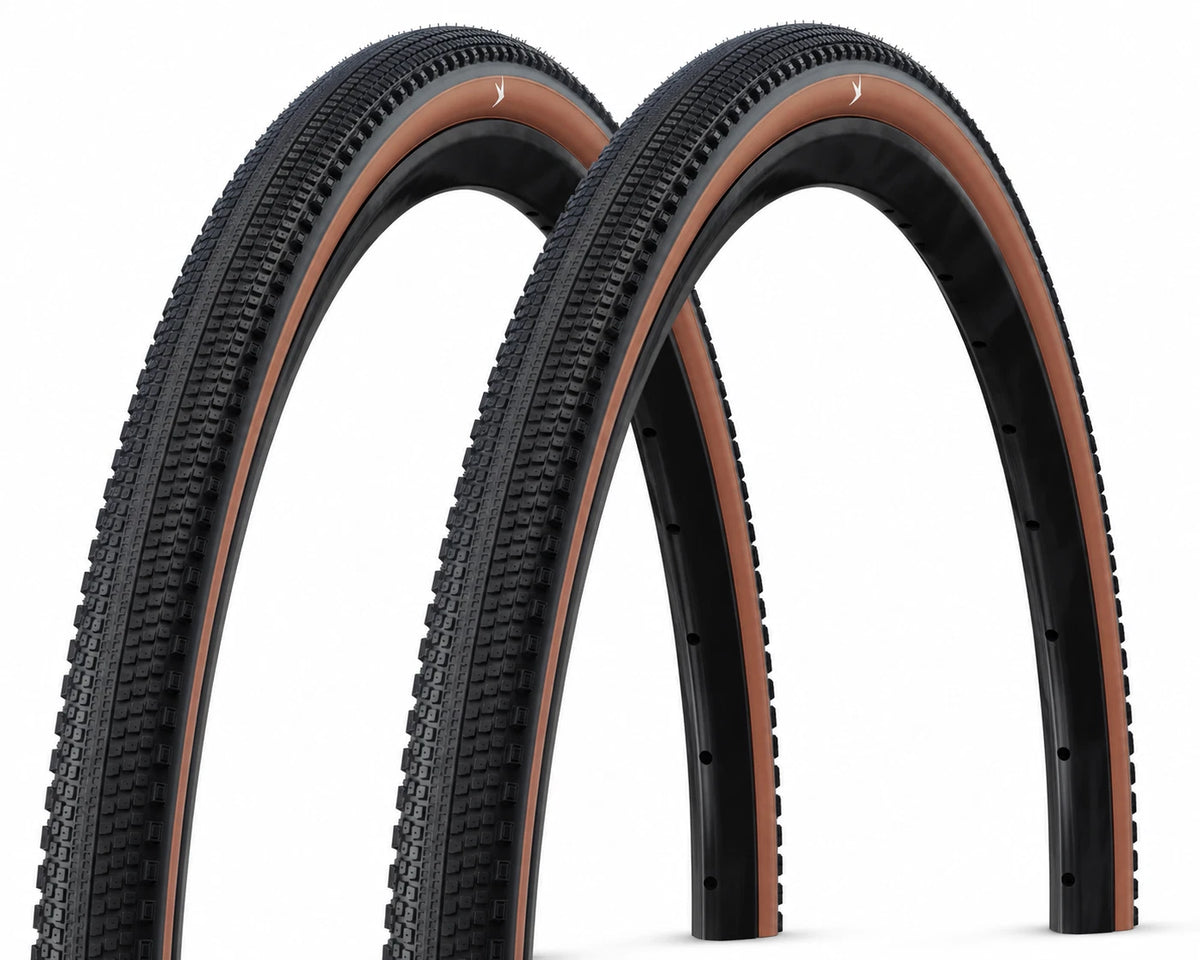 2x Schwalbe G-One Comp gravel tyres 700x40mm with bronze accents, designed for gravel biking and cornering grip.