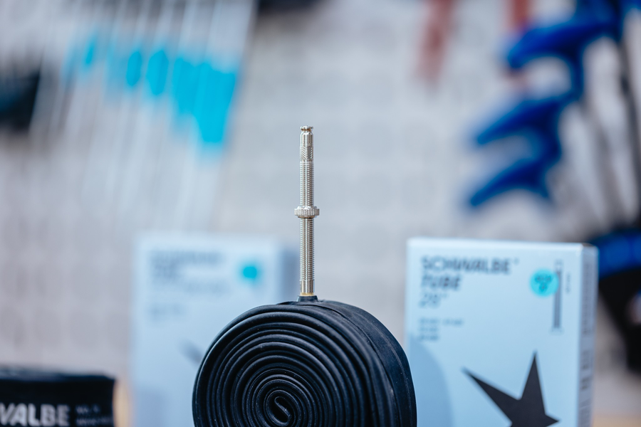 Schwalbe SCV4 16 x 1 3/8" - 18 x 1.35" Clik Valve Inner Tube 40mm with valve standing upright in focus.