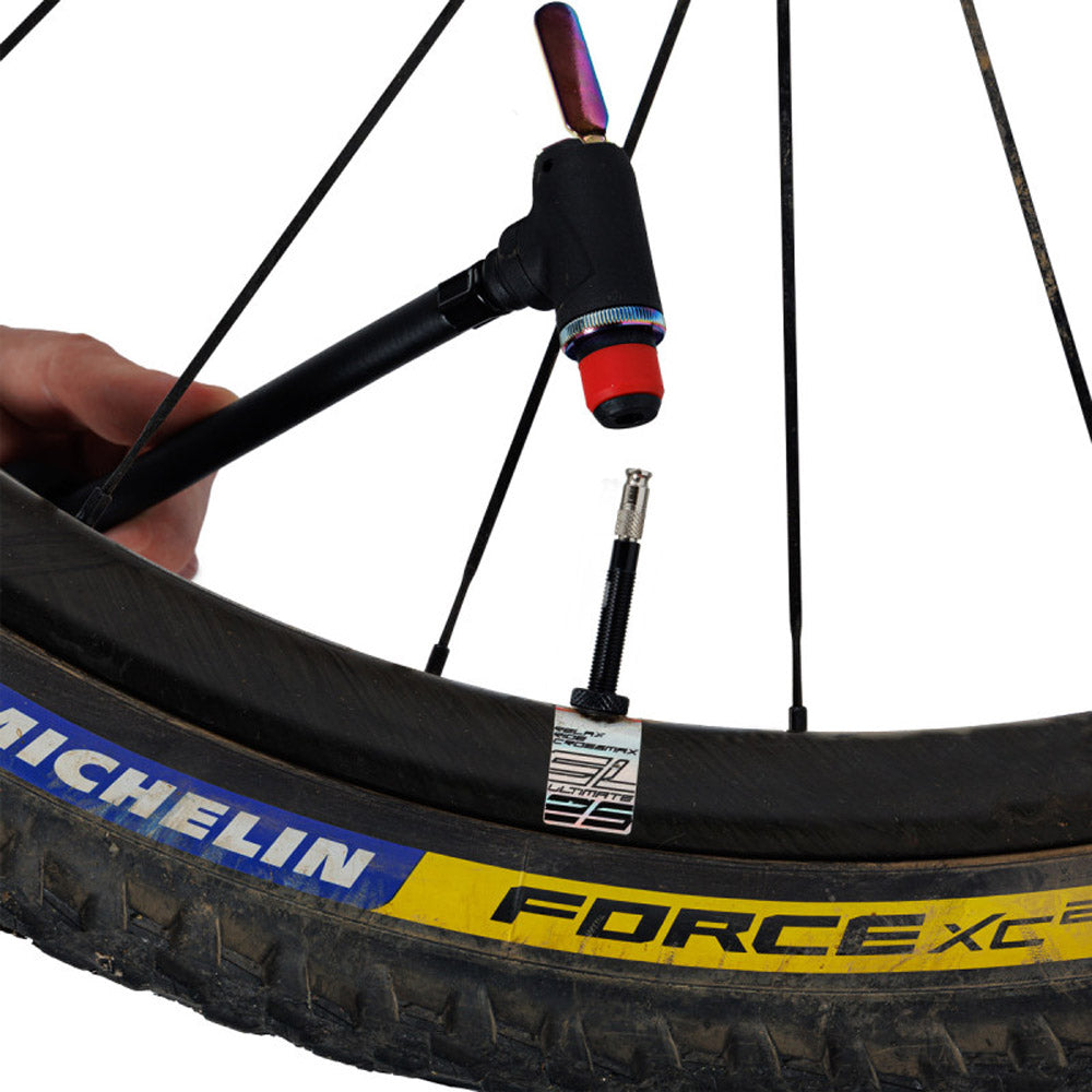 Zefal Clik valve adapter for bike pumps attached to a bicycle wheel for easy inflation.