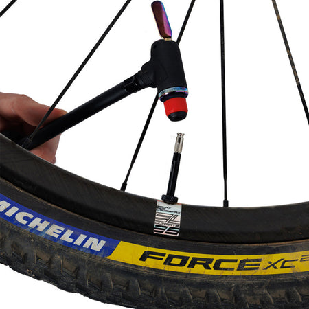 Zefal Clik valve adapter for bike pumps attached to a bicycle wheel for easy inflation.